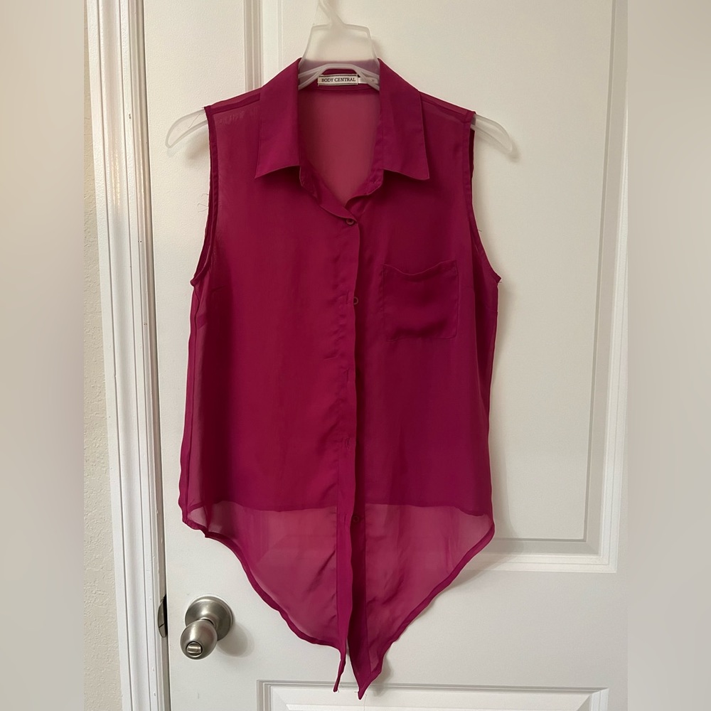 It’s a sheer magenta top. It’s ties in the front.